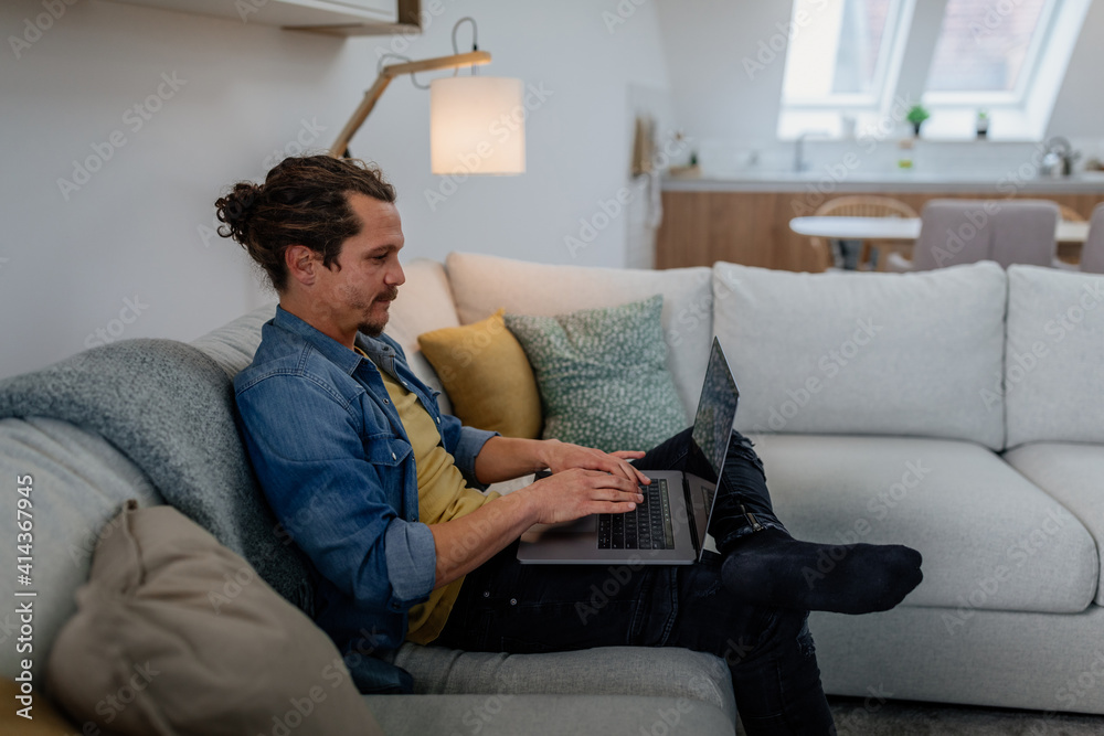 Man using laptop at home Man using laptop at home