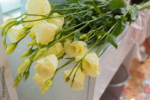 Yellow roses flowers bouquet on table. Festive event, present, surprise concept.