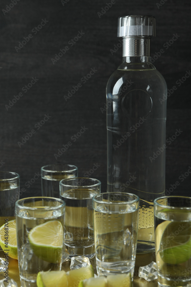 Tray with shots and bottle of vodka on wooden background Tray with shots and bottle of vodka on wooden background