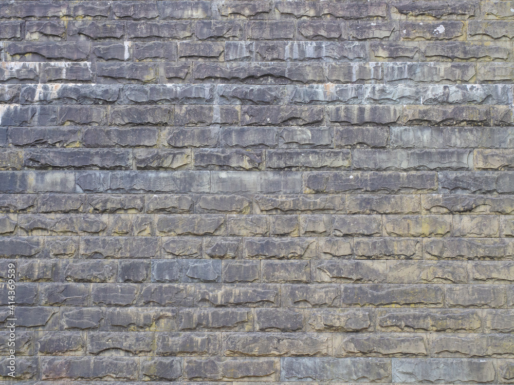 The wall with rough textured masonry is covered with stains and darkened. Not a geometric seamless pattern The wall with rough textured masonry is covered with stains and darkened. Not a geometric seamless pattern