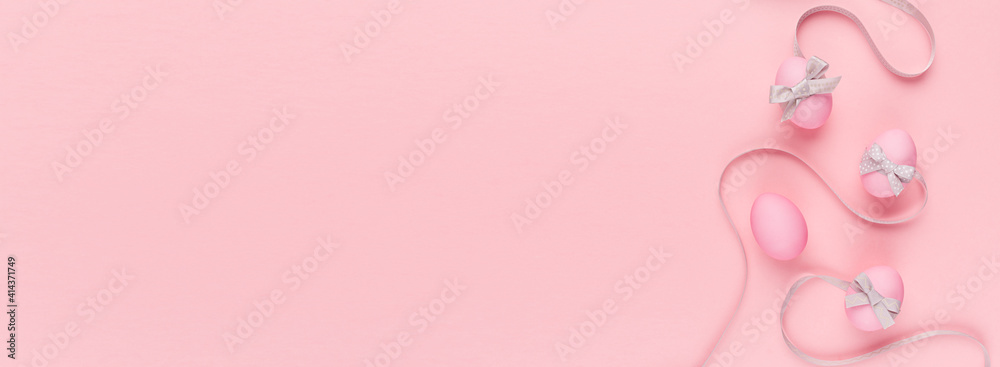 Cute and naivety easter banner with pink eggs and wavy grey ribbons on pastel pink backdrop.
