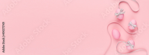 Cute and naivety easter banner with pink eggs and wavy grey ribbons on pastel pink backdrop. © finepoints