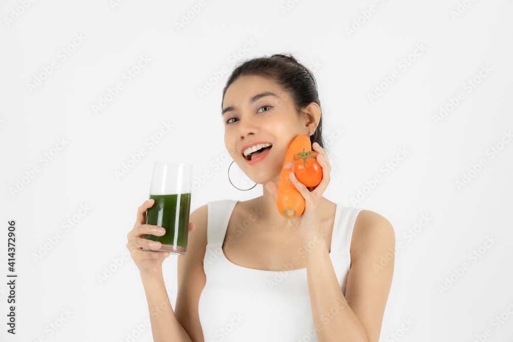 Beautiful young Asian woman drinking green detox vegetable smoothie over white isolated background. Fitness and health care concept, Vegetarian drink juice, Healthy lifestyle. Beautiful young Asian woman drinking green detox vegetable smoothie over white isolated background. Fitness and health care concept, Vegetarian drink juice, Healthy lifestyle.