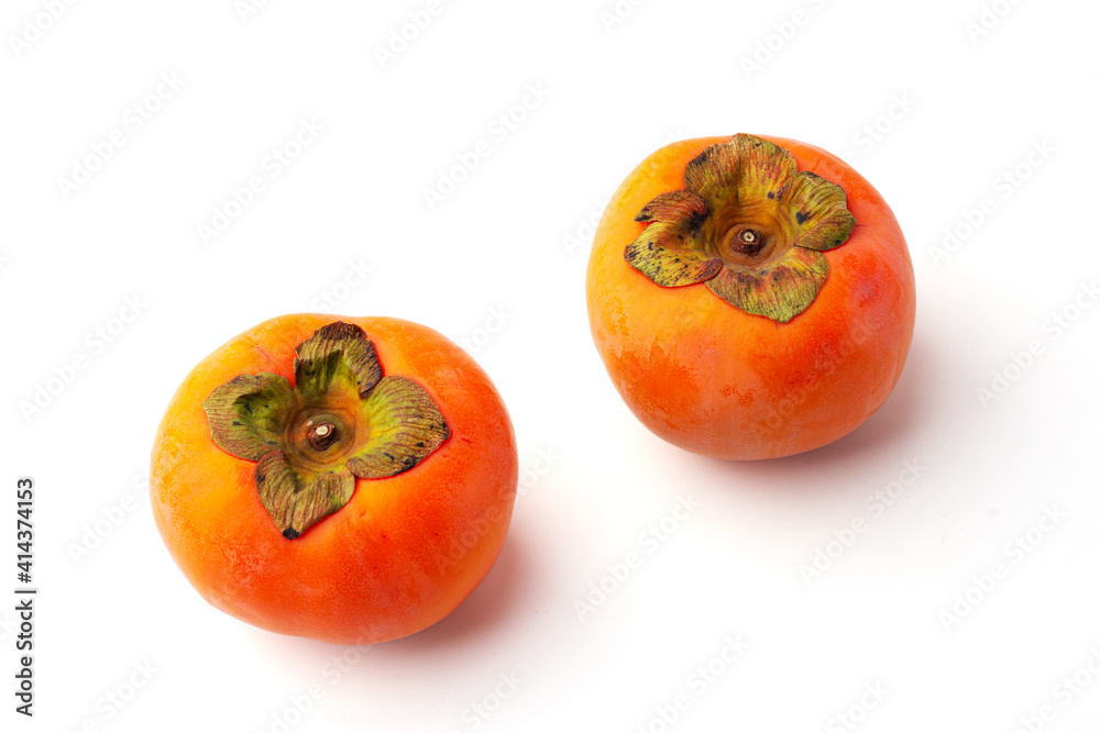 2 ripe persimmon isolated on a white background. 2 ripe persimmon isolated on a white background.