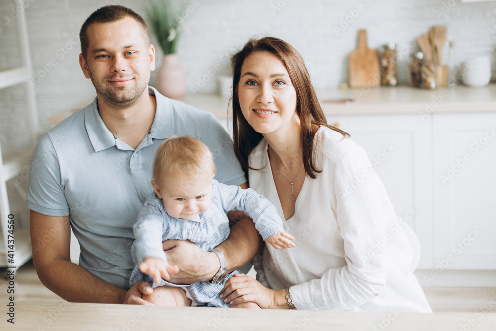 Happy family and infant daughter together at home. Childhood, family concept Happy family and infant daughter together at home. Childhood, family concept