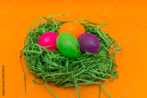 Four Colorful Easter Eggs Sitting in Green nest or Grass