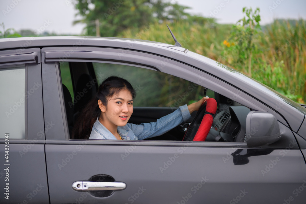 Beautiful young asian woman happy smiling woman driving her car. Car insurance concept..