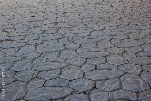 Sidewalks are laid out with tiles of a chaotic shape.
