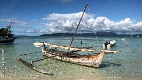 White sand and transparent sea water. Nosy Iranjia near Nosy Be in Madagascar. Two islands connected by a tongue of sand influenced by the tide. Typical Malagasy boat. Panoramas of Madagascar.  Love.
