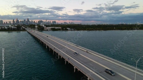 Wallpaper Mural Aerial view of cars on the Bear Cut Bridge, during sunset, Miami skyline background, Florida - tilt up, drone shot Torontodigital.ca