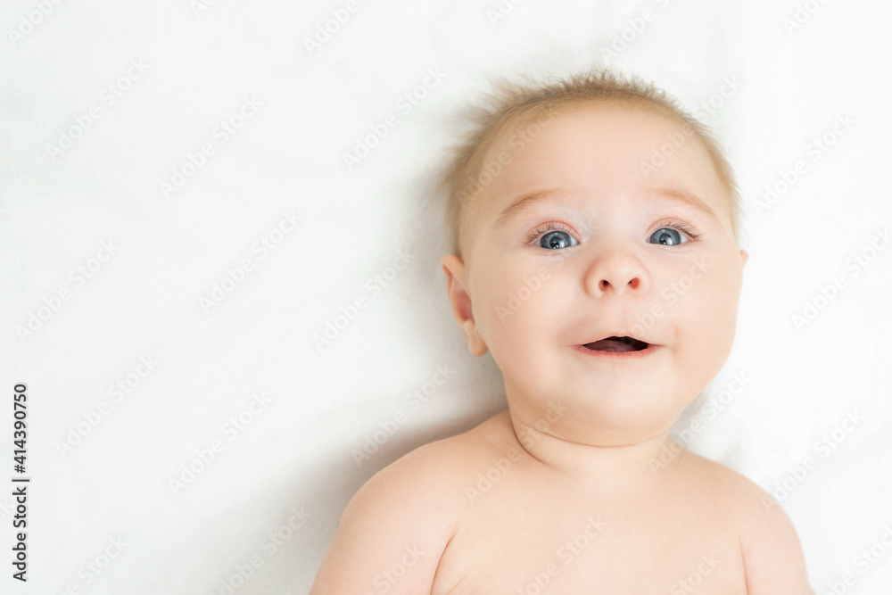 Beautiful smiling cute baby. Close-up portrait of a happy crawling baby looking at camera. Laughing little boy on white background with copy space Beautiful smiling cute baby. Close-up portrait of a happy crawling baby looking at camera. Laughing little boy on white background with copy space