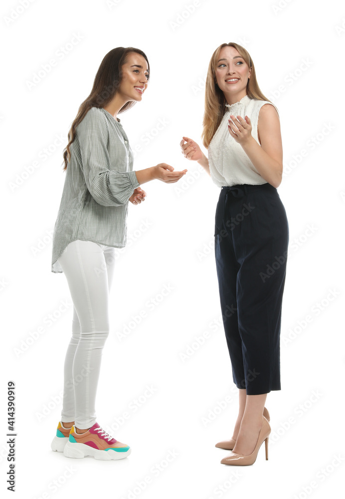 Young women in casual clothes talking on white background Young women in casual clothes talking on white background