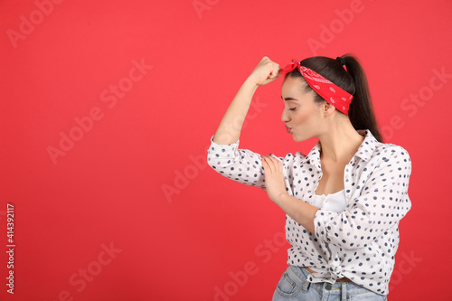 Strong woman as symbol of girl power on red background, space for text. 8 March concept