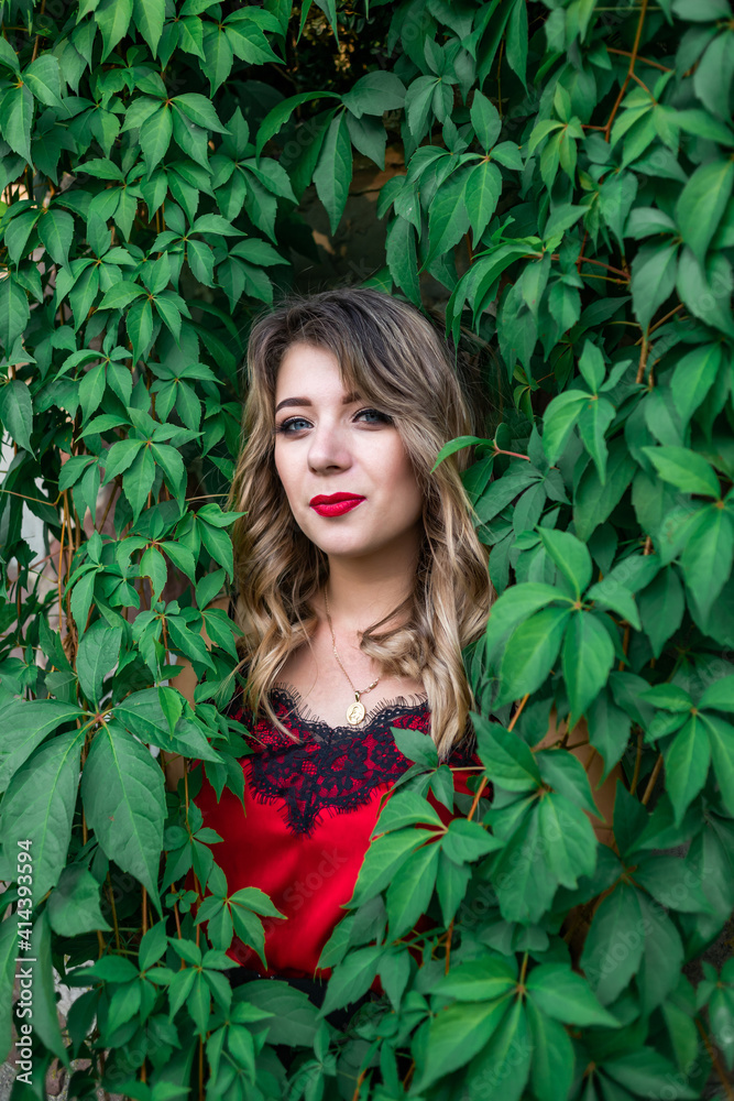 portrait of the woman in green leaf, red lipstick