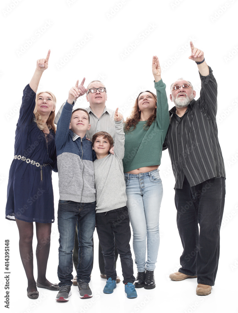in full growth. happy big family pointing somewhere up. in full growth. happy big family pointing somewhere up.