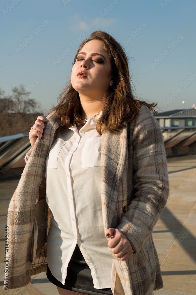 Woman in winter jacket and white shirt