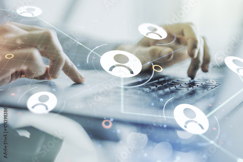 Double exposure of social network icons concept with hands typing on laptop on background. Marketing and promotion concept