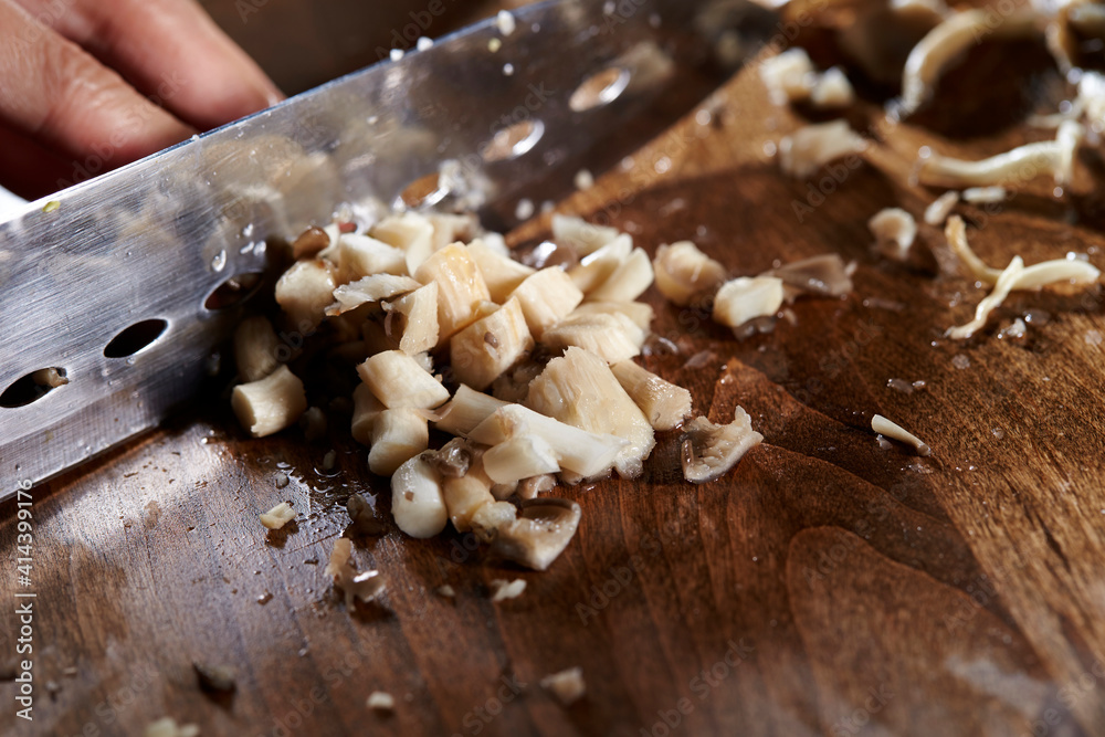 Fototapeta premium Cook chopped mushrooms on the board