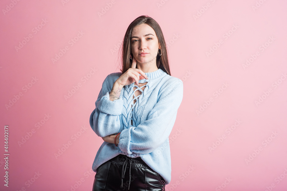 Thoughtful brunette girl in studio on pink background Thoughtful brunette girl in studio on pink background