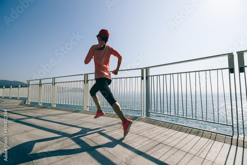 Healthy lifestyle fitness sports woman runner running on seaside trail © lzf
