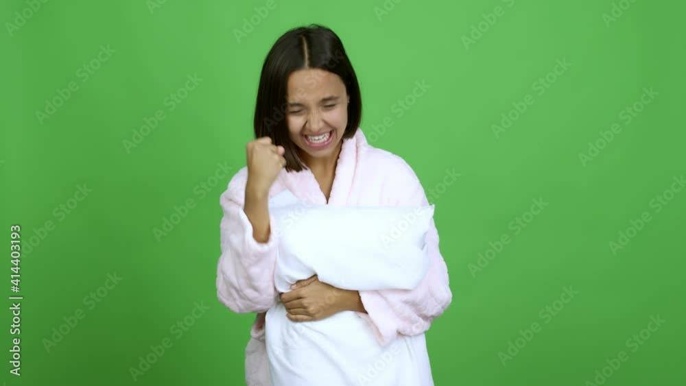 Woman in pajamas celebrating a victory and surprised to be successful over isolated background
