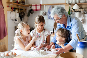 Cooking at Home. Family having fun together. Grandmother and kids baking bread, making Easter cake and holiday dinner in cozy kitchen. Children chef. Lifestyle authentic moments. Candid true emotions
