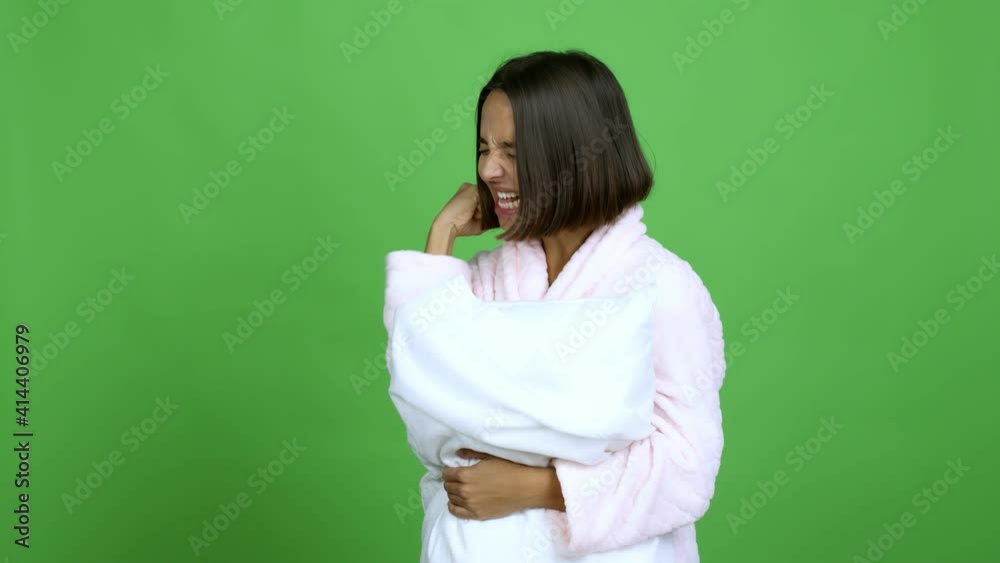Woman in pajamas celebrating a victory over isolated background Woman in pajamas celebrating a victory over isolated background