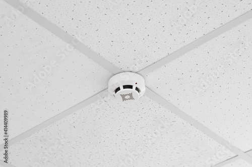 Ceiling-mounted fire safety sensor. Modern ceiling smoke detector © Анастасія Шатирова
