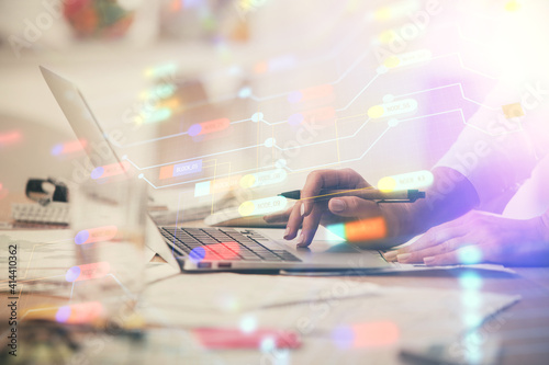 Double exposure of woman hands working on computer and data theme hologram drawing. Tech concept.