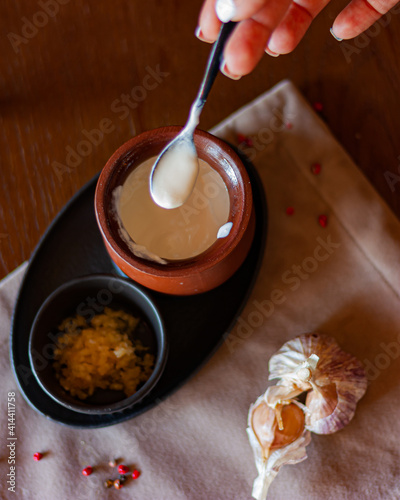  white sauce with garlic in a clay pot