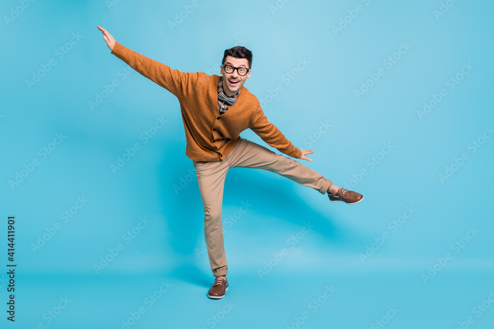 Full body photo of funky happy cheerful man make place wings dance isolated on pastel blue color background