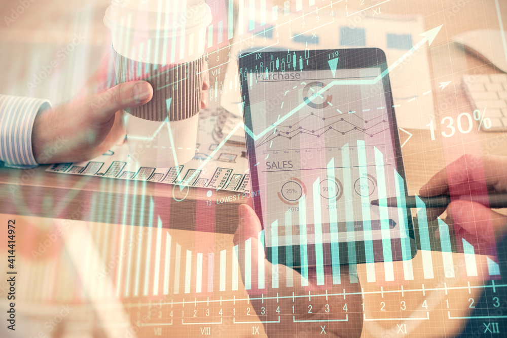 Double exposure of man's hands holding and using a phone and financial chart drawing. Market analysis concept.
