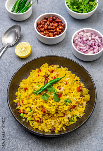 spicy Indian snack or breakfast  poha with onion and peanuts