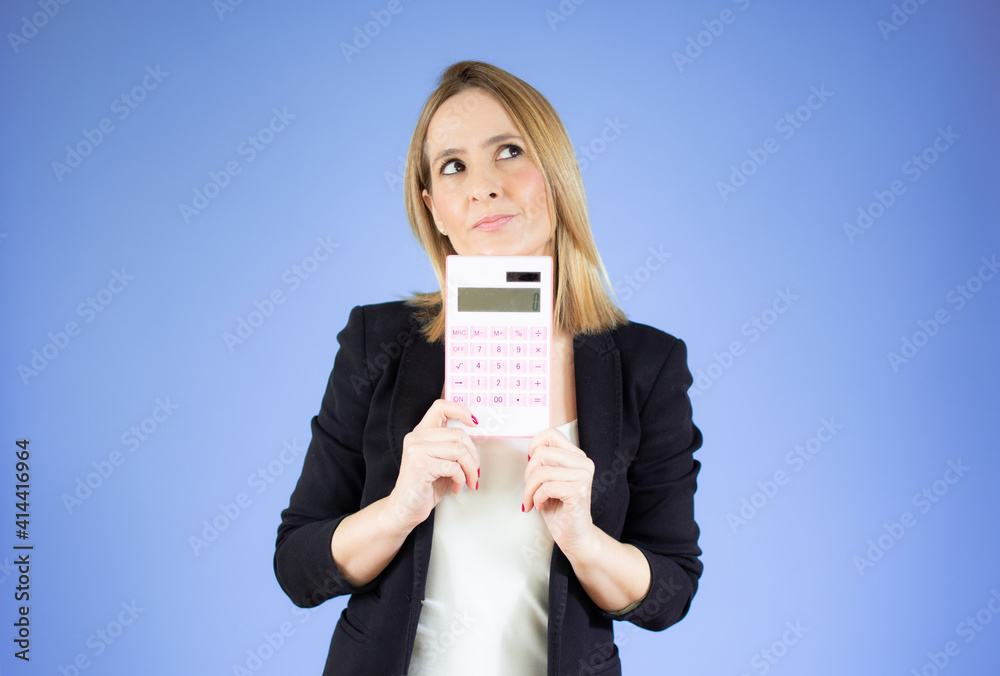 Young business woman hold digital calculator over purple background. Young business woman hold digital calculator over purple background.