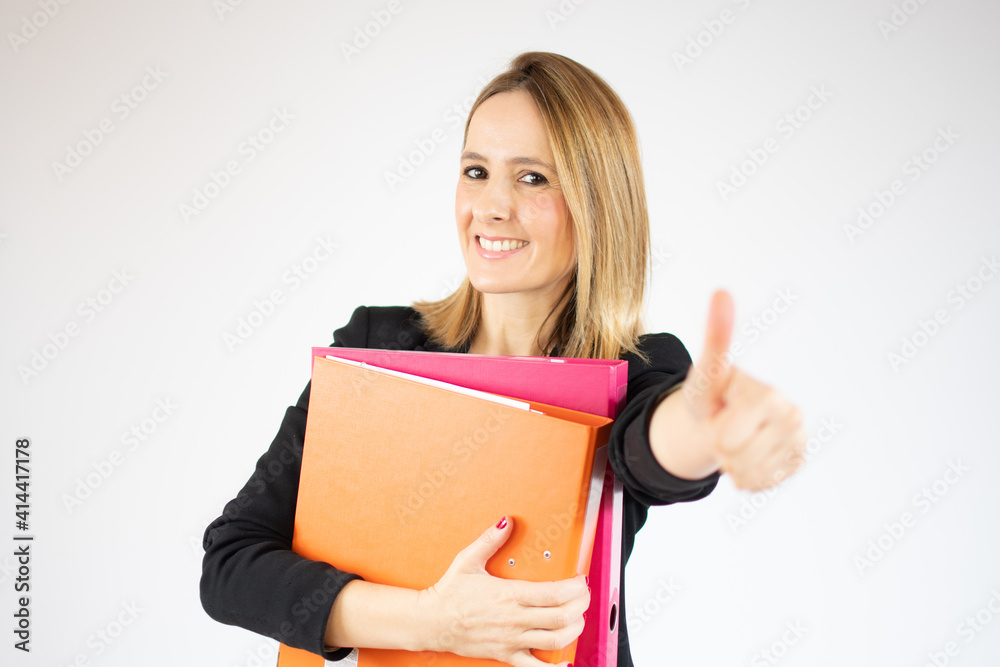 Young business woman holding file cabinets with thumb up over white background.