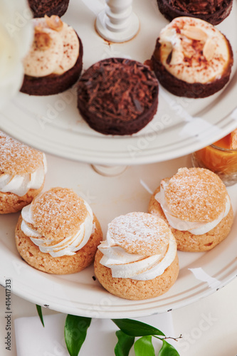 Profiteroles on the festive table. Sweet catering. Assorted desserts. Close-up