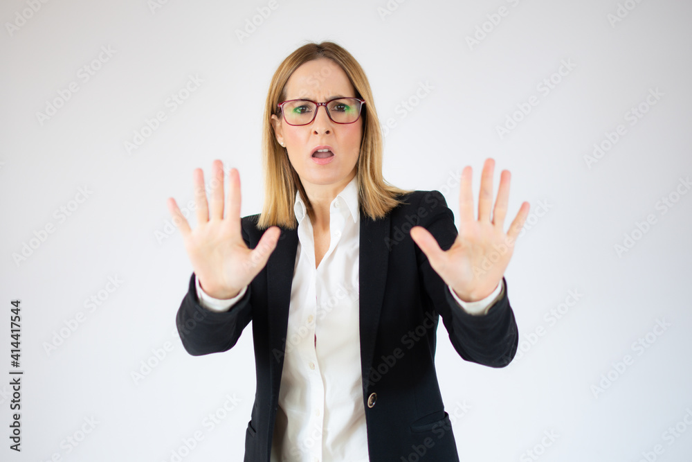 Young business woman doing stop gesture over white background Young business woman doing stop gesture over white background