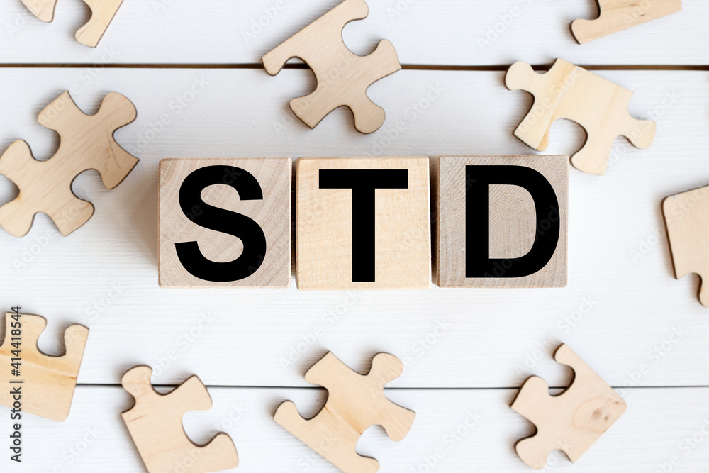 Obraz premium STD . on wooden cubes on a white background. wood puzzles