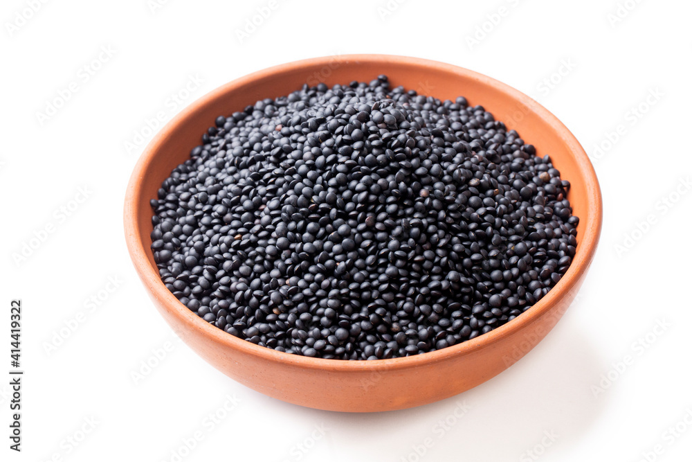 Portion of Black Lentils (detailed close-up shot) isolated on white background Portion of Black Lentils (detailed close-up shot) isolated on white background