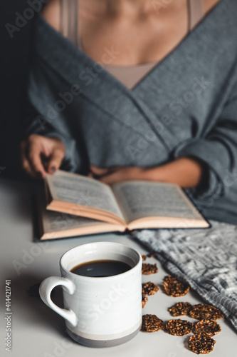 Woman reading a book and having breakfast. Top view. Healthy healthy breakfast.