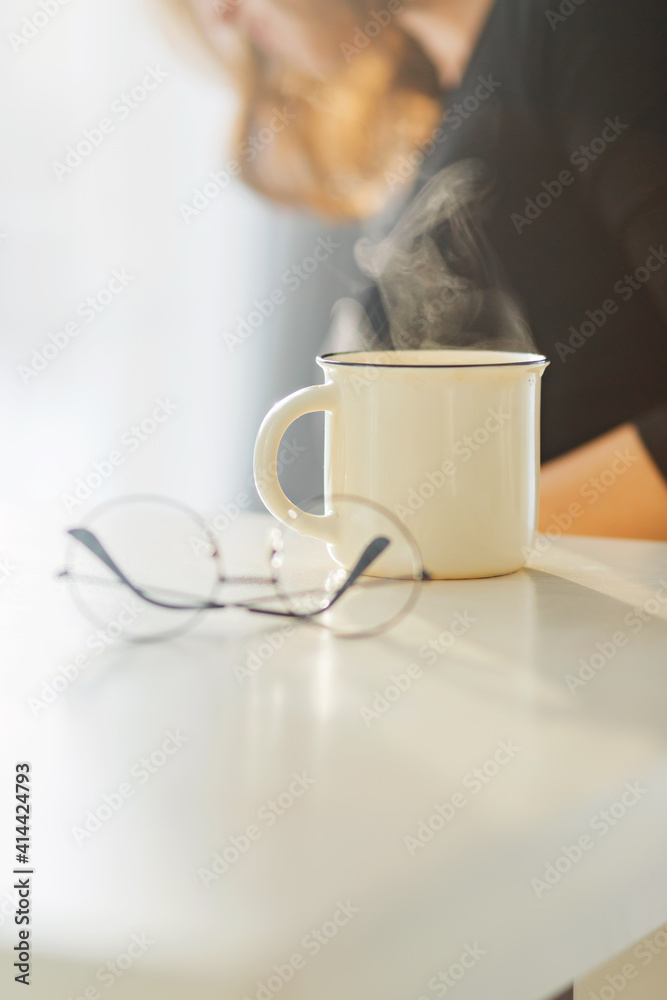 Happy and comfortable at home in morning, Beautiful young woman drinking tea near window at home Happy and comfortable at home in morning, Beautiful young woman drinking tea near window at home
