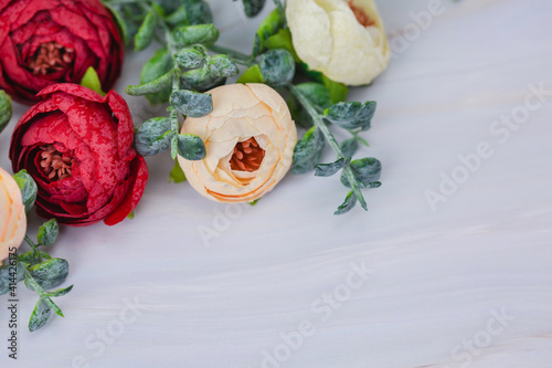 Bouquet of artificial flowers on marble background