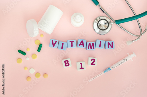 Cubes with the text Medical supplies on the table with tablets and a syringe.