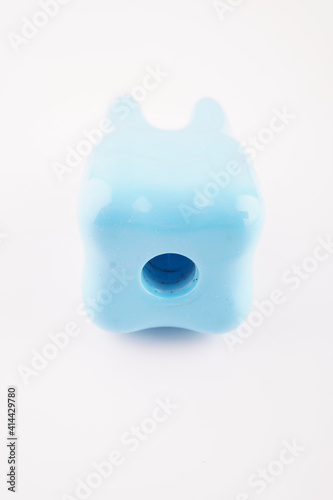 plastic toy tooth on white background