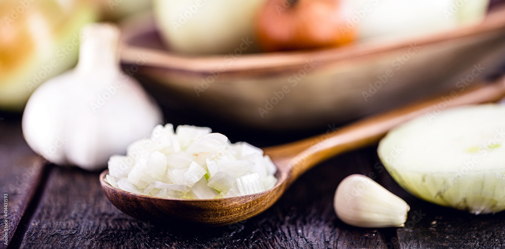 wooden spoon with roasted onion and crushed into pieces to be used as seasoning, spot focus