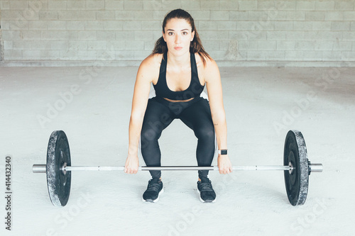 Fitness woman holding barbell