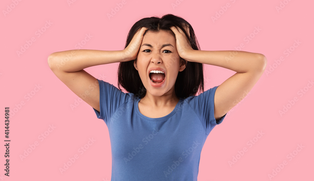 Portrait of young emotional asian woman screaming Portrait of young emotional asian woman screaming