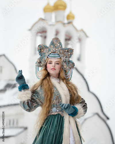 A girl in national Russian dress against the background of a church with golden domes photo