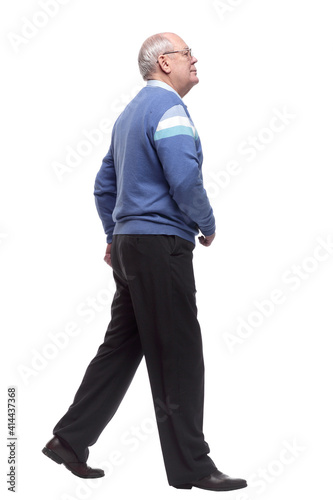 side view. an elderly man confidently striding forward.