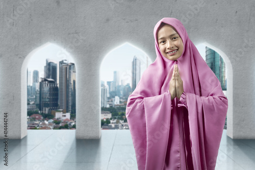 Asian Muslim woman in veil with greeting gesture